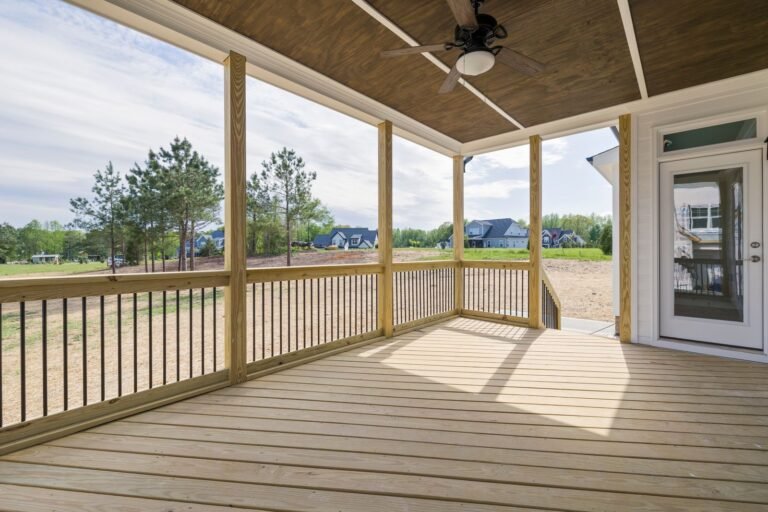 Covered wood deck with a ceiling fan and open sides