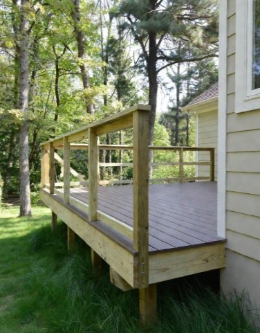 Raised wood deck with wooden railing