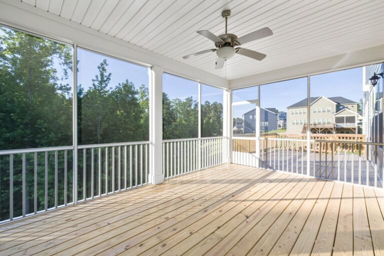 Screened porch with white ceiling and ceiling fan